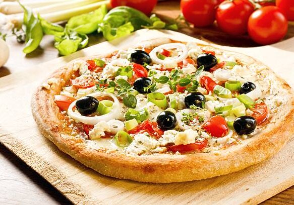 Fresh homemade greek style pizza with olives, feta cheese and onion rings